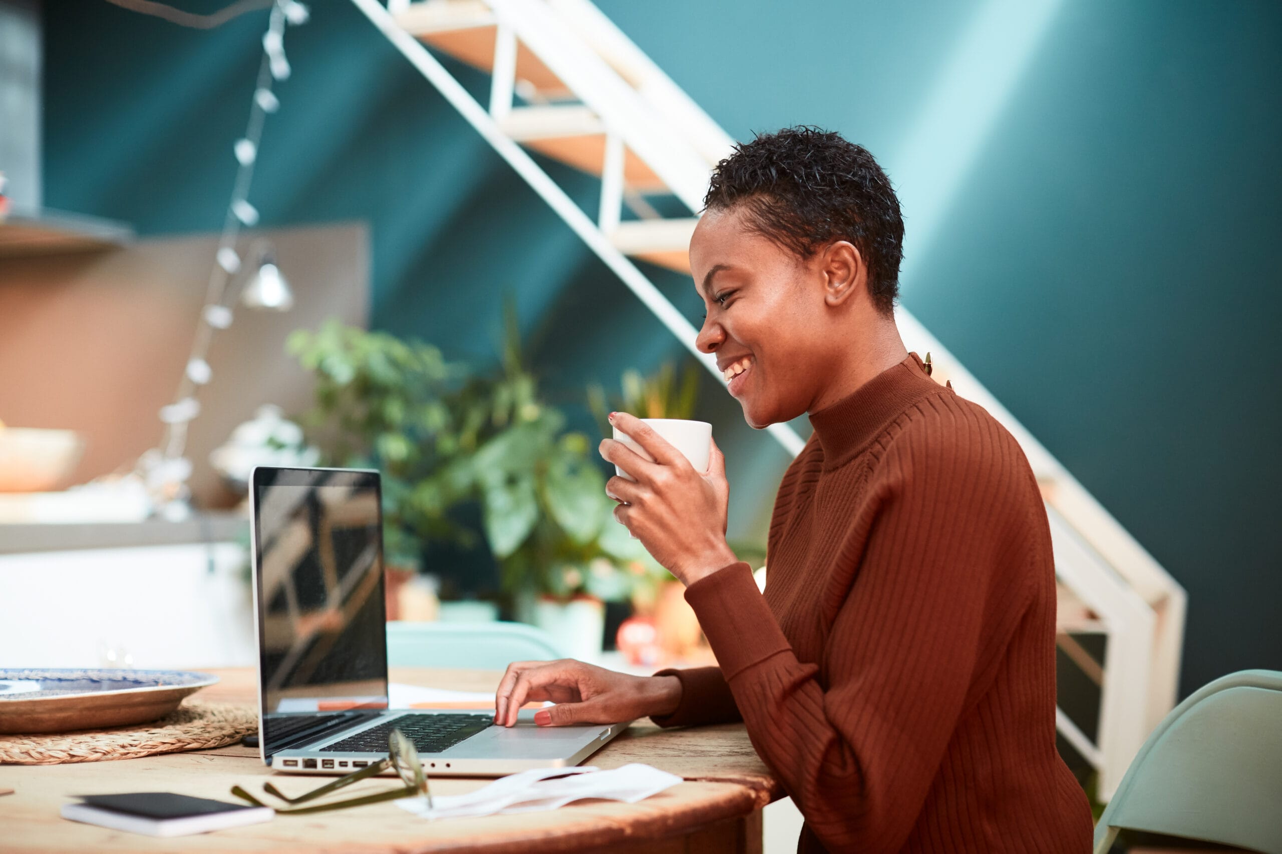 Woman working on her finances at home, filling up tax forms.