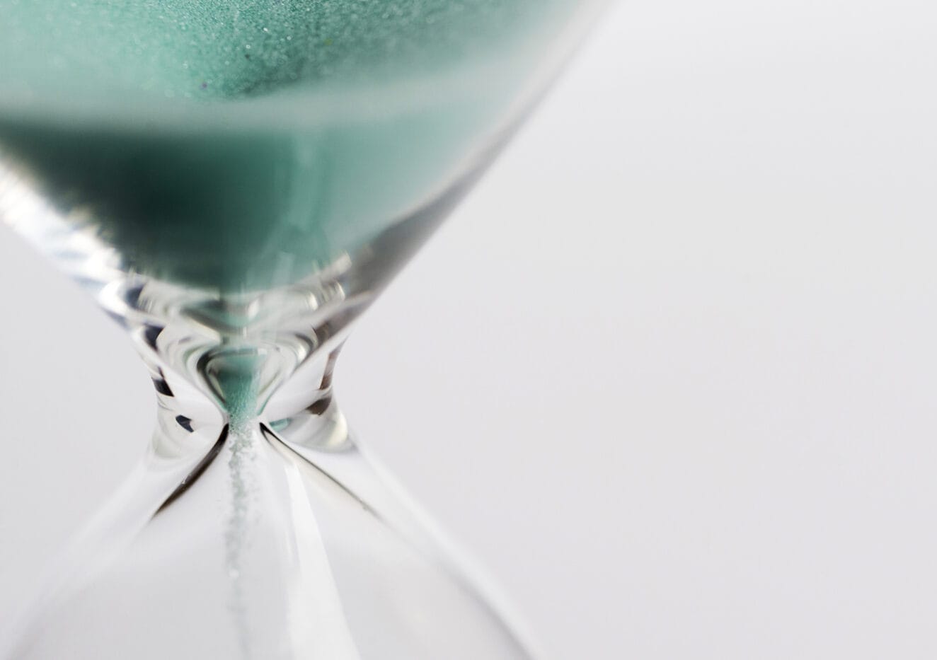 Hourglass close-up on a white background, place under the text.